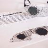 Close up of safety glasses containing the Myopia insert in front of a tactile map of the United States. This image gives an idea of how an individual with Myopia would see the map