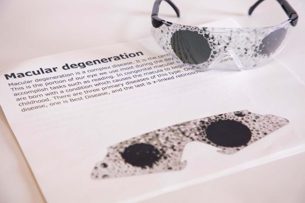 Close up of safety glasses containing the Myopia insert in front of a tactile map of the United States. This image gives an idea of how an individual with Myopia would see the map