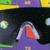 Close up of safety glasses containing the Retinitis Pigmentosa insert in front of a tactile map of the United States. This image gives an idea of how an individual with Retinitis Pigmentosa would see the map
