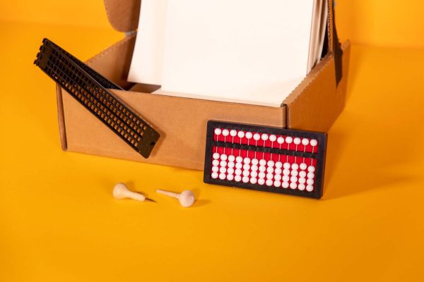 student starter pack box containing abacus, transcribing paper, and cell slate with saddle stylus