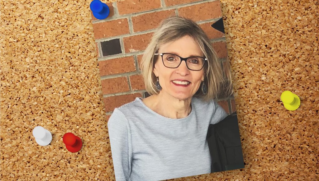 A photo of Lanna smiling pinned to a corkboard.