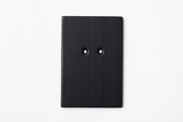 Single, two-hole drilled black rectangle-shaped card