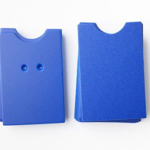 A package of blue “puzzle”-shaped cards (10 undrilled and 5 two-hole drilled)