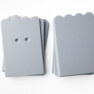 A package of gray scalloped-shaped cards (10 undrilled and 5 two-hole drilled.