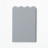 Single, undrilled gray scalloped-shaped card