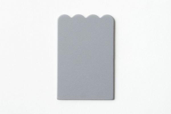 Single, undrilled gray scalloped-shaped card
