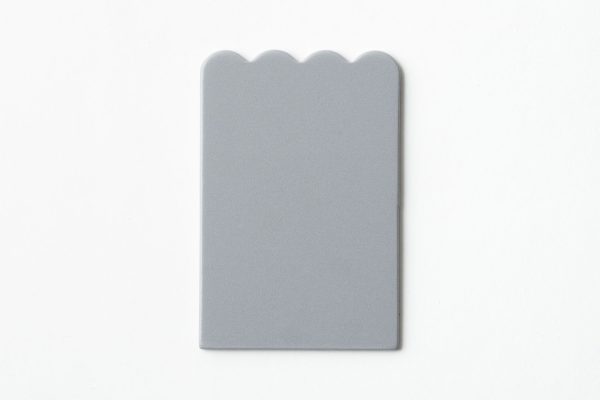 Single, undrilled gray scalloped-shaped card