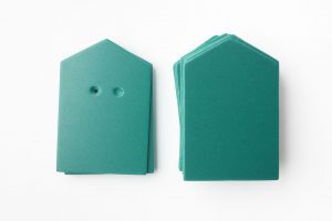 A package of green “house”-shaped cards (10 undrilled and 5 two-hole drilled)