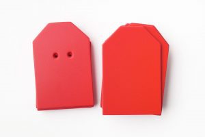 A package of red “barn”-shaped cards (10 undrilled and 5 two-hole drilled)