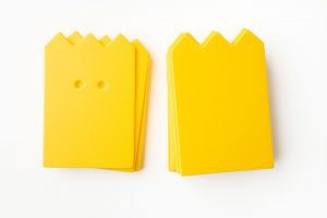 A package of yellow “crown”-shaped cards (10 undrilled and 5 two-hole drilled).