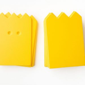 A package of yellow “crown”-shaped cards (10 undrilled and 5 two-hole drilled).