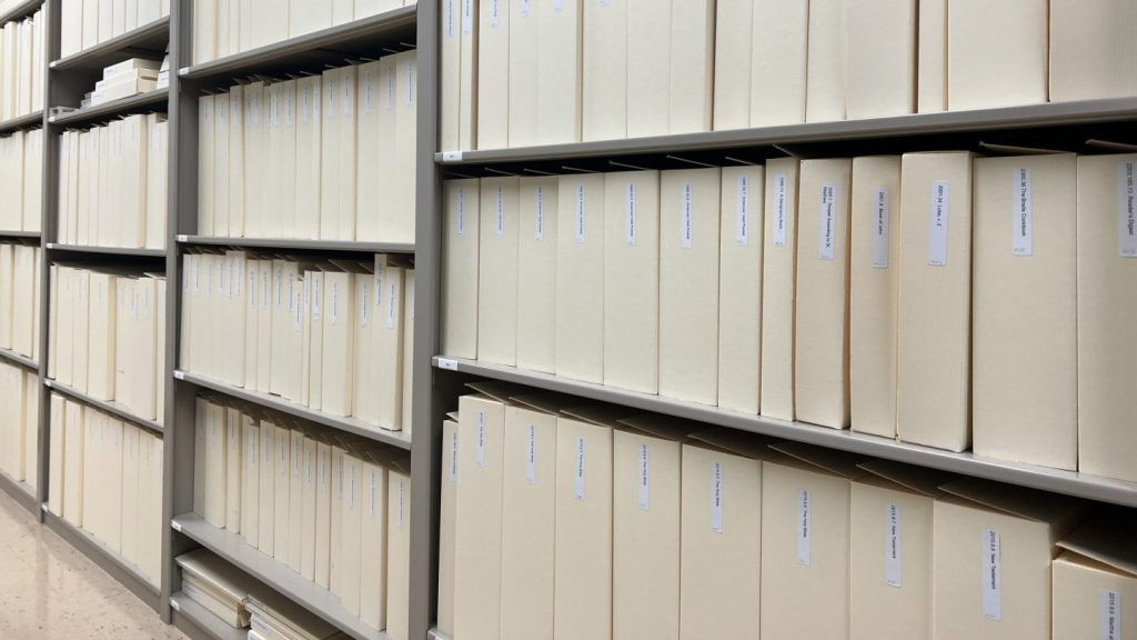 Shelves of boxes, varying in size, in a museum archive.