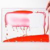 Zoomed out image of a red swirly mat over a white background.