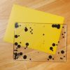 Black swirly mat with stars and circles on the inside placed on top of a yellow tabletop mat.