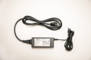 Jupiter power supply consisting of a black power cord plugged into a black AC Adapter