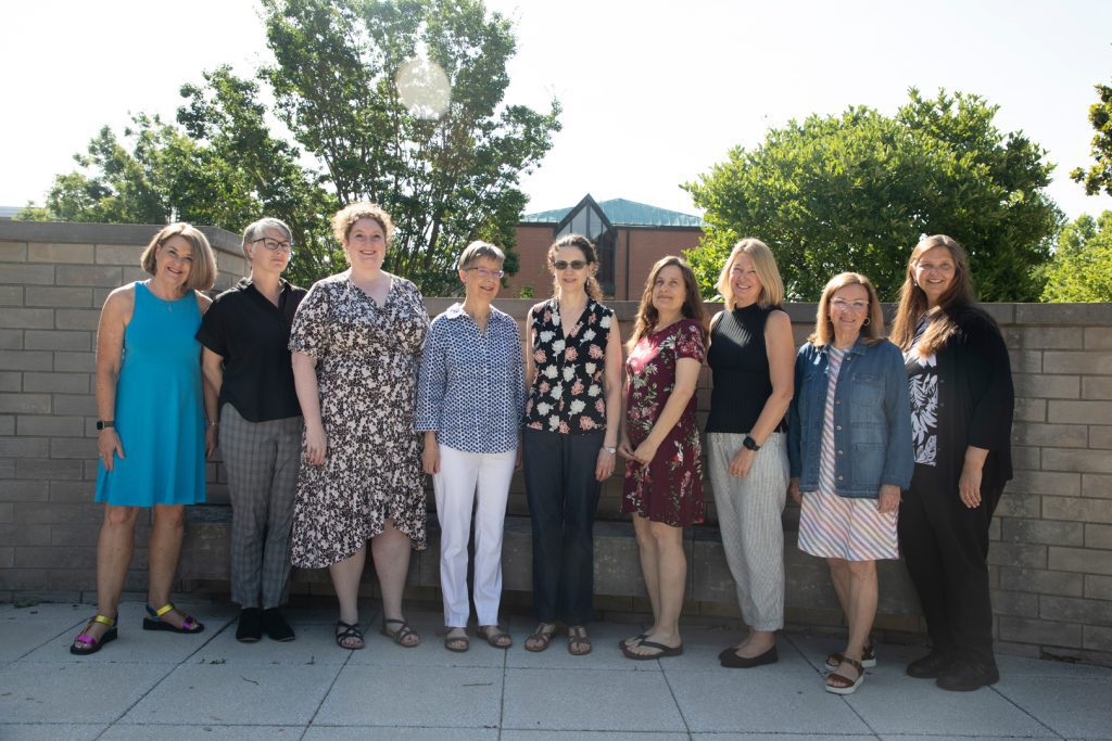 A group of women smiling and posing for a photo.