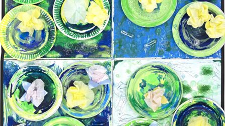 Detail of a painting in shades of blue and green. Plastic ramekin tops float like lily pads in a painted pond.