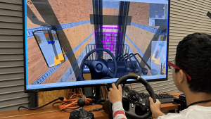 A student using a forklift driving simulator.
