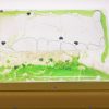 Swirly Mats FVA green and clear mat with silver heart confetti on top of an APH LED Light Box.