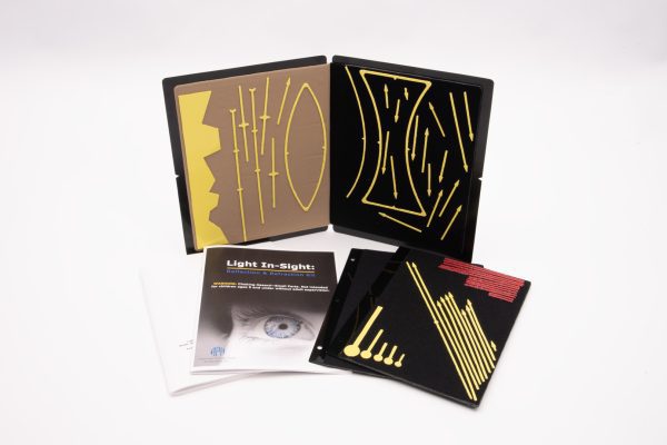 Light In-Sight Kit displaying a black working board with yellow stick-on drawing pieces that represent light reflection and refraction concepts. Two storage panels with different diagrams and an instruction booklet lay spread out in front of the working board.
