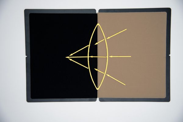 A diagram of the reflection of light made from the yellow stick-on pieces displayed on the Light In-Sight working board.