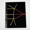 A diagram representing refraction made from yellow and red stick-on pieces that rest on top of a black storage panel.