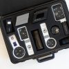Multiple magnifiers and magnifier holders resting inside the black case included in the kit.