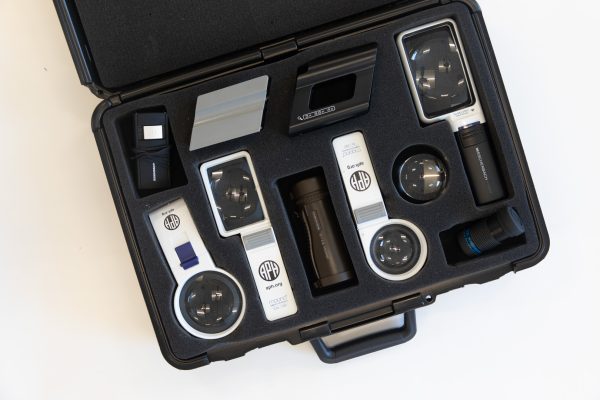 Multiple magnifiers and magnifier holders resting inside the black case included in the kit.