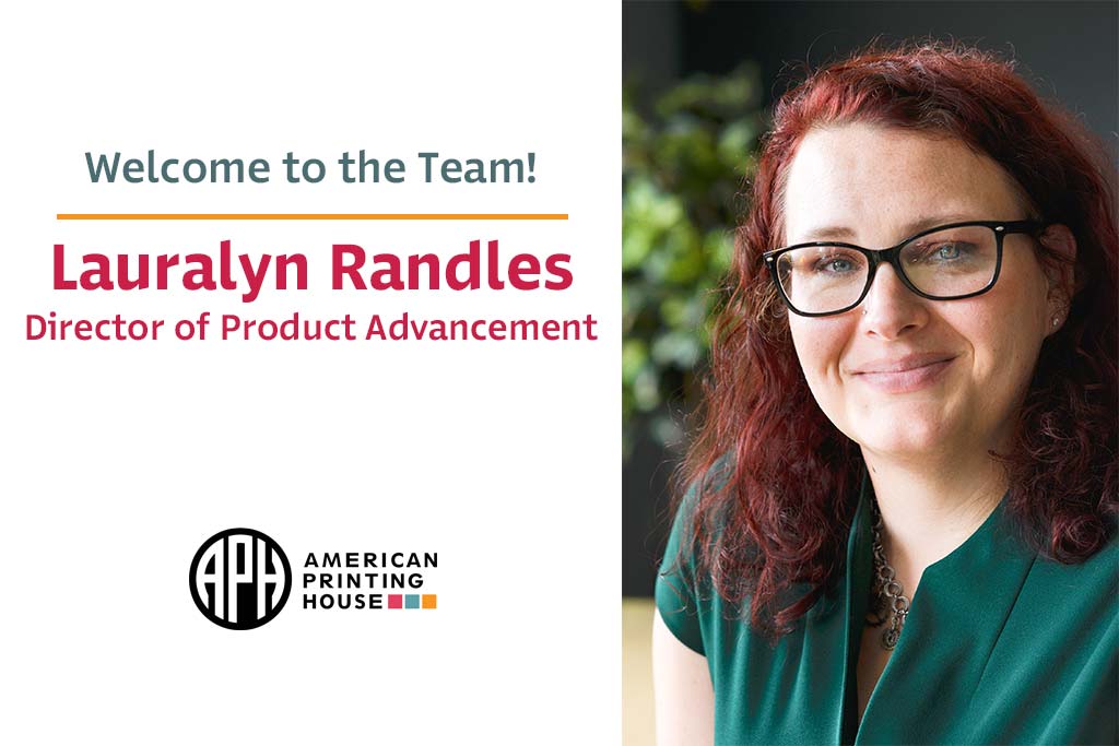 Portrait photo of Lauralyn. A red, curly-haired woman with black-rimmed glasses and a green shirt sits outside with foliage in the background. Text reads "Welcome to the Team! Lauralyn Randles Director of Product Advancement" APH logo