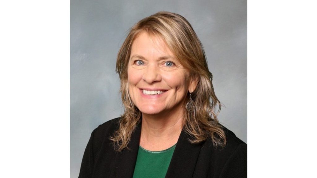 Professional headshot of Jennifer Bliss, who is smiling and wearing a dark blazer.