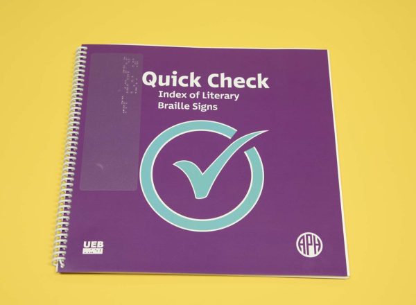 Quick Check Index of Literary Braille Signs UEB edition is a spiral-bound book featured over a yellow background. On the purple cover resides a large blue check mark in the middle, a UEB logo in the bottom left-hand corner, and the APH logo in the bottom right-hand corner.