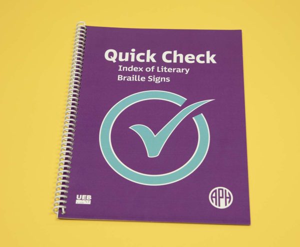 Quick Check Index of Literary Braille Signs Print edition is a spiral-bound book featured over a yellow background. On the purple cover resides a large blue check mark in the middle, a UEB logo in the bottom left-hand corner, and the APH logo in the bottom right-hand corner.