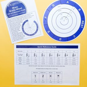 Overhead view of the complete Music Braille Wheel Kit, including the physical wheel, Use and Resource Guide, and the Quick Reference Guide.