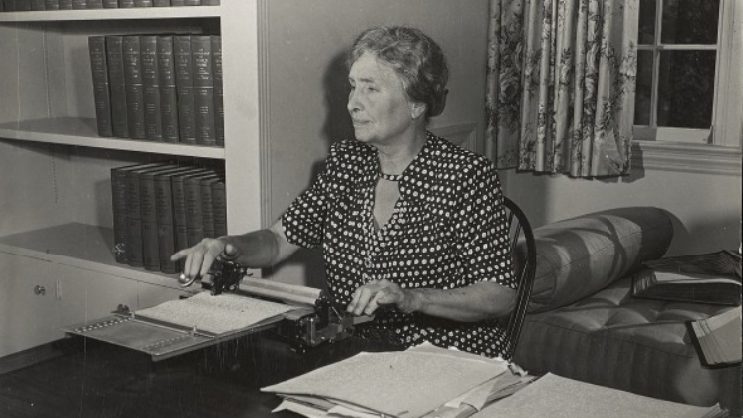 Helen Keller writes with the Pyke-Glauser braillewriter in her office.