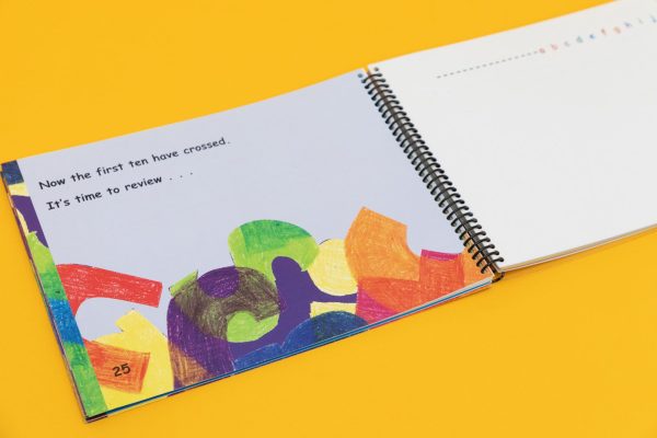 Two open illustrated pages of Alphabet Scramble with the words "Now the first ten have crossed. It's time to review..."