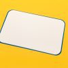 A white magnetic dry erase board included in the Sports Courts kit. The edges of the board are blue, and it sits against a yellow background.
