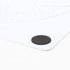 An adhesive-backed magnetic coin attached to the back corner of a tactile layout. These are used to attach the layout to the magnetic dry erase board.