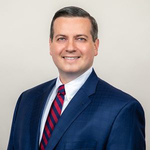 David Nigro bio photo wearing suit and tie