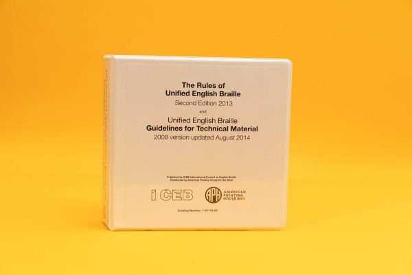 The white Rules of UEB large print binder standing upright against a yellow background. The cover contains the title, the catalog number, and both ICEB and APH logos.