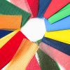 Close up of an assortment of texture strips arrayed in a circle. The strips include flocked styrene, craft foam, and both rough and bumpy textures in a variety of colors.