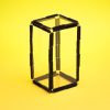 Four clear plastic rectangular pieces arranged with two squares on a yellow background to form a rectangular prism.