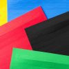 Close up of overlapping perforated border strip sheets in a variety of colors.