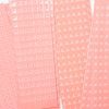 Close up of overlapping perforated shape strips including circles, squares, triangles, and stars.