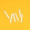 : A close up of six white U-Channels laid out on a yellow background.