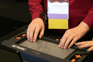 A student places their hands on a tactile graphic displayed on the Monarch refreshable braille display.