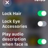 The settings screen on the Flip-Over FACES app. Options displayed include "lock hair," "lock eye accessories," and "play audio description when face is change." In the top right corner is the time, and there is an X in the top left to exit the settings screen.