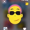 Screenshot on the Apple Watch of an animated yellow man with spikey pink hair and sunglasses. In the top left corner is an "X" to exit from that face, and on the right is the time. There is a heart in the bottom right corner, and an audio button on the left.