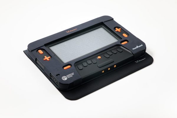 Top-down view of the Monarch's face. In the top center is the orange logo, a butterfly graphic next to the text "Monarch." On either side of the braille display screen are navigation keys and below is a Perkins style braille keyboard. The Monarch sits at a 45 degree angle on a white background.
