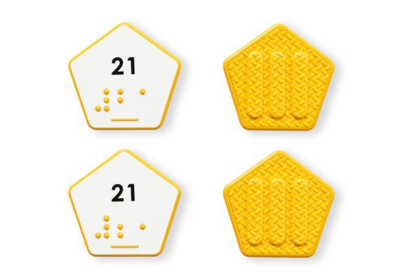 Comparison of two yellow hexagon number tiles showing the differences between UEB and Nemeth for the number 21.