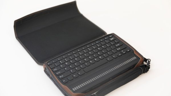 An overhead shot of a MantisQ40 in a turtleback case sitting on a white background. The case is open, and the face of the Mantis is visible.